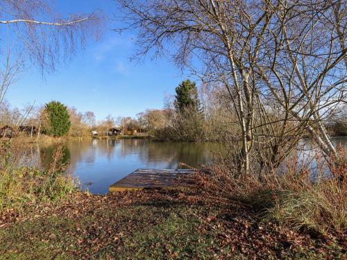 a view of a lake with a wooden dock at 10 Duck Lagoon in Tattershall