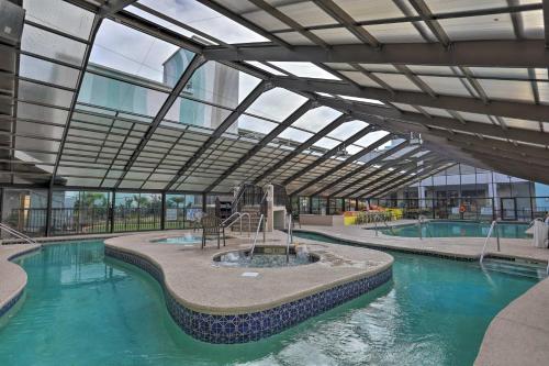 an indoor swimming pool with a large glass ceiling at Oceanfront Myrtle Beach Rental with Pool! in Myrtle Beach