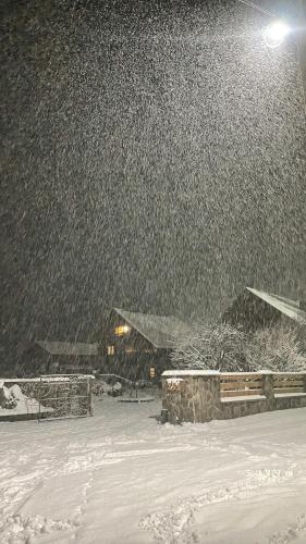 a snow storm with a building in the background at Готель Жди ня Єво instagram zhdenievo hotel in Zhdenievo