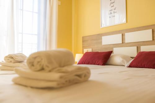 a bedroom with two towels on a bed at Apartagal-Costa Reinante Spa in Barreiros