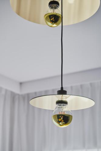 aandelier hanging from a ceiling in a room at Stay inn Hotel Warszawa in Warsaw