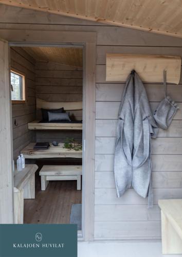 a sauna with a fish hanging on the wall at Hirsihuvila Villa Letto, pihasauna & ulkoporeamme in Kalajoki