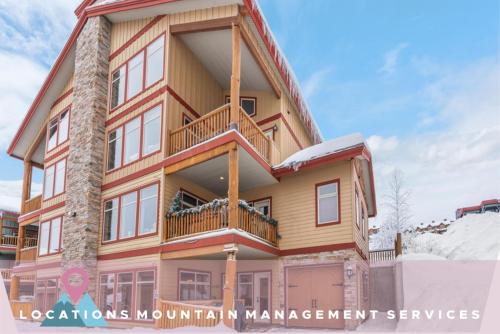 a large building with a balcony on top of it at I Spy - Cozy Pet Friendly, Ski In Ski Out Condo with Private Hot Tub in Big White