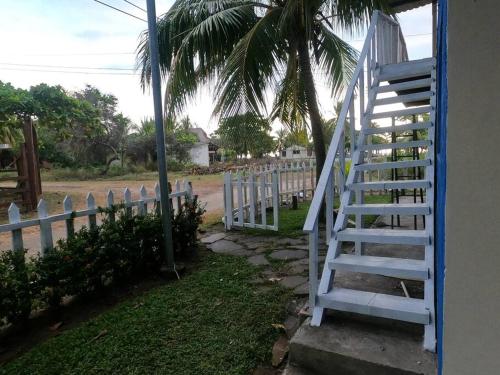 a white staircase next to a white fence at MALIBU HOUSE 