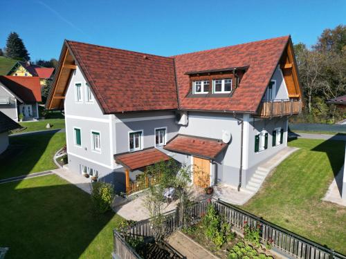 a large white house with a red roof at Mühlbauerhof in Großklein