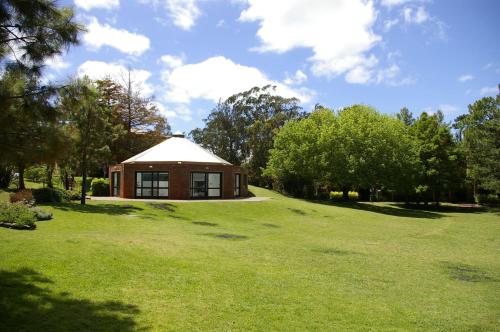 a small building in the middle of a green field at Rincon del Este Resort in Punta del Este