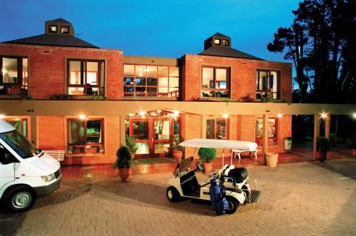 a golf cart parked in front of a building at Rincon del Este Resort in Punta del Este