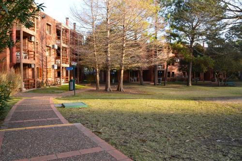 a walkway in a park next to a building at Rincon del Este Resort in Punta del Este