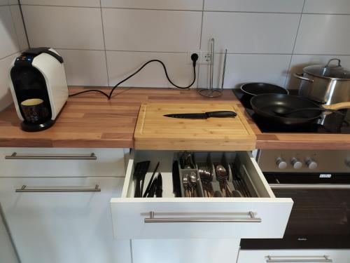a kitchen with a counter with a stove top oven at Andris Apartments in Stuttgart