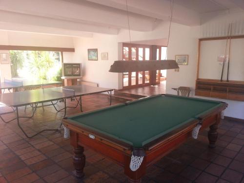a pool table in a room with two tables at Rincon del Este Resort in Punta del Este