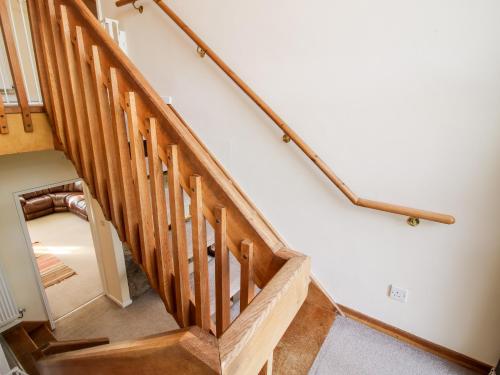 a staircase in a home with wooden railings at Bicton Lea in Acton