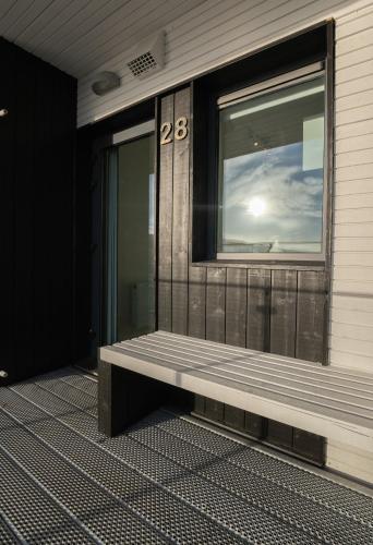 a window on the side of a building with a bench at Stylish Aparthotel in Tórshavn in Tórshavn