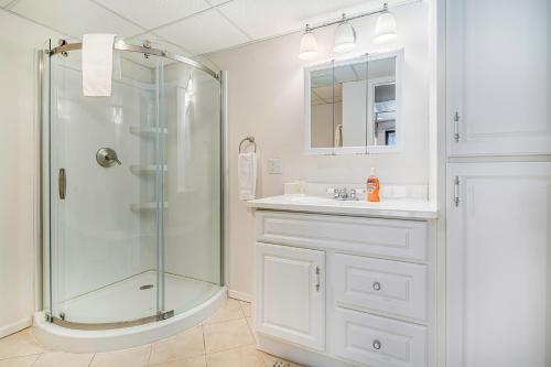 a white bathroom with a shower and a sink at Hideaway Valley Condo 36 in Harbor Springs