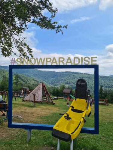 a sign with a slide at a playground at Chata pri Veľkej Rači in Oščadnica