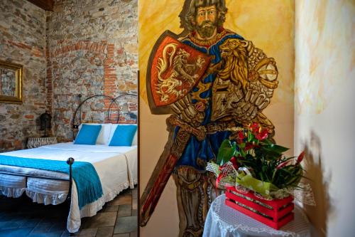 a room with a painting of a man with a sword at Luxury Corte Di Re Artù in Lucca