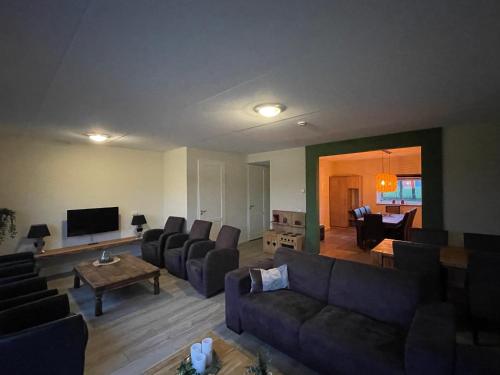 a large living room with couches and a television at B&B Hof 't Sprakel in Haaksbergen