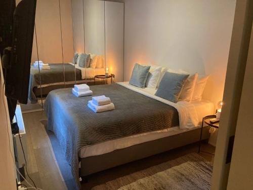 a bedroom with a large bed with towels on it at Luxury Suites Princess in Antwerp