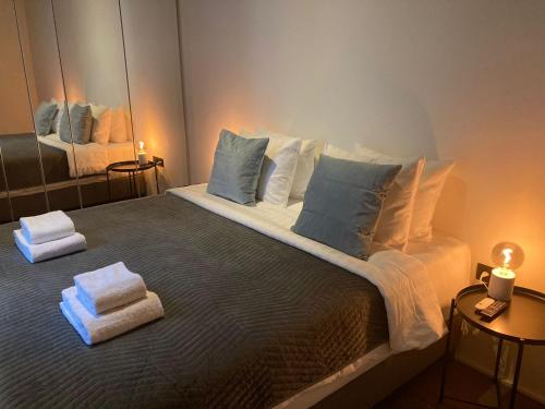 a bedroom with a large bed with towels on it at Luxury Suites Princess by Rikas Hotels in Antwerp