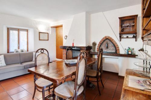 a kitchen and living room with a table and a couch at Stone House of the year 1500 in Moltrasio