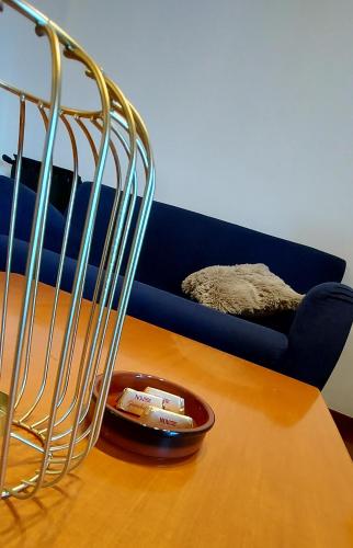 a living room with a table and a blue couch at Il sole in Carpi