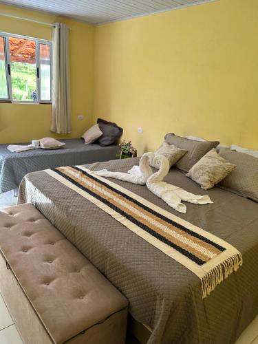 two beds sitting next to each other in a room at Pousada Sal da Terra in Carrancas