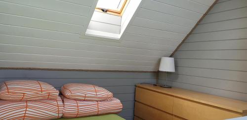 a bedroom with a bed and a lamp and a window at Domki Primore in Władysławowo