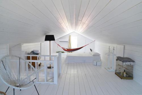 a room with a hammock in the middle of a room at Koukouapartments & Suites in Vathi