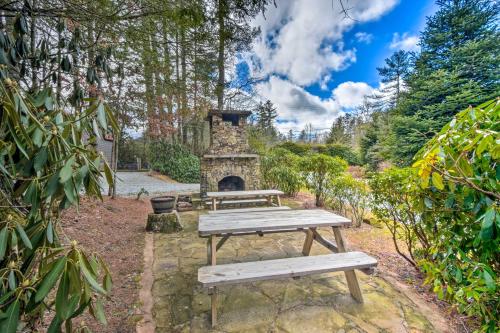 a picnic table and a stone fireplace in a garden at Highlands Vacation Rental - Walk to Main St! in Highlands