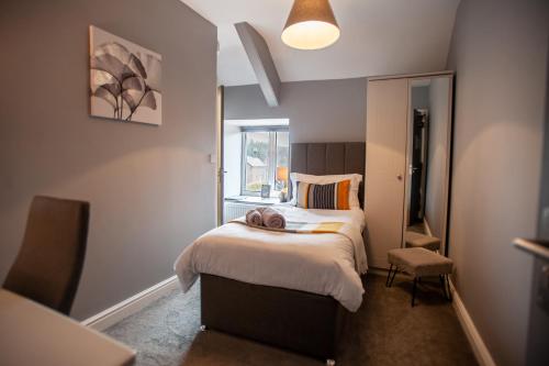 a small bedroom with a bed and a window at The Slate in Bangor