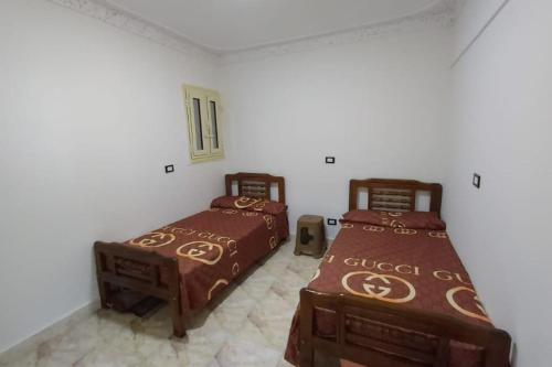 two beds sitting in a room with at Paradise Beach Alexandria Sea View - Free Wi-Fi - Alex in Alexandria