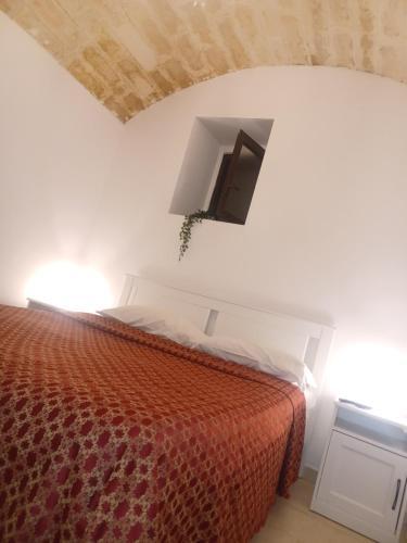 a bedroom with a bed and a tv on the wall at Filioli Apartment in Bari