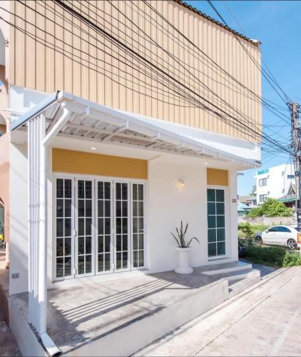 a white house with awning in front of it at Beach Block No.5 at Huahin Beach in Hua Hin