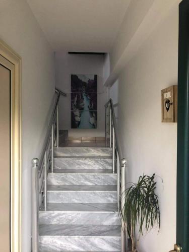 a staircase in a house with a painting on the wall at The Olive View Apartment by Ceni, Elbasan in Elbasan