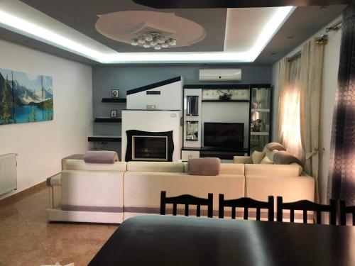 a living room with a couch and a fireplace at Villa Ceni 2 in Elbasan