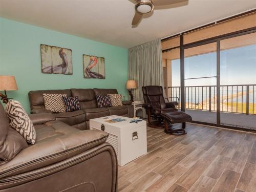 a living room with a couch and a balcony at Laguna Reef #413 - Waters Edge in Rockport