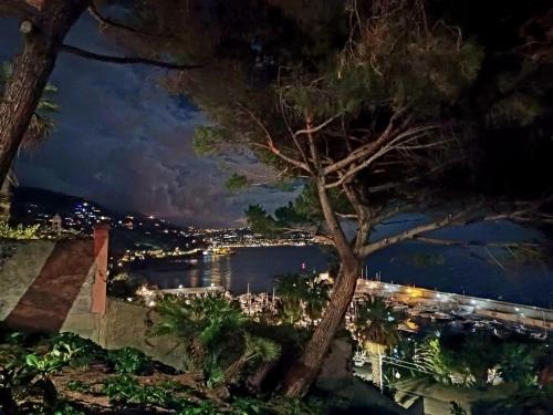 a view of the water at night at Villa Gaia - Luxury Villa, pool & wellness rooms in Bordighera
