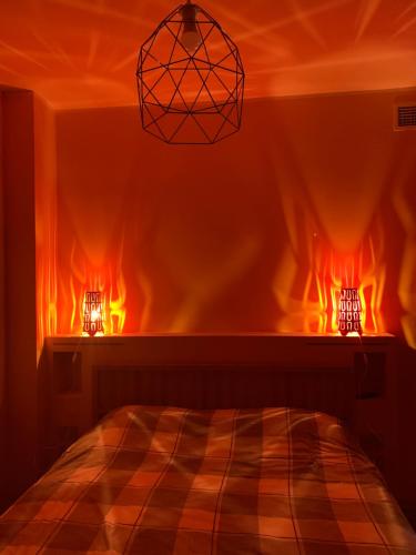 a room with a bed and a chandelier at Sala dell Estate Guest House in Secchia
