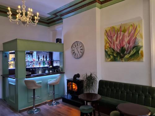 a bar with a fireplace and a clock on the wall at Beverley Dean - Children Over 5 Years Welcome - Continental Breakfast in Blackpool