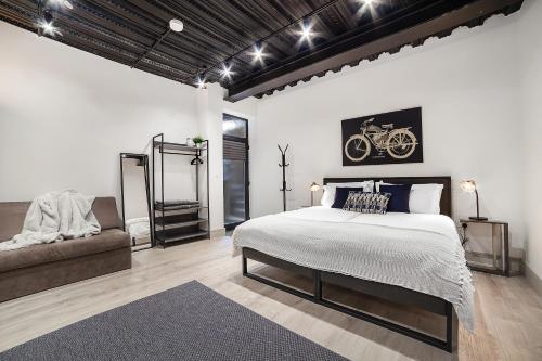 a bedroom with a large bed and a couch at Modern Luxury Studios London in London
