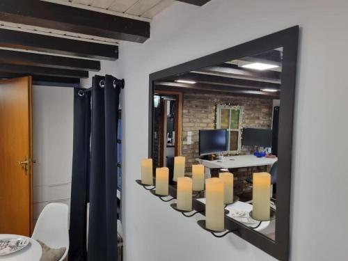 a mirror with a row of candles on a wall at altes romantisches Fachwerkhaus in Rheinnähe auch für Workation geeignet in Cologne