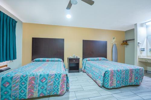 a hotel room with two beds in a room at Texas Inn San Benito near Harlingen in San Benito