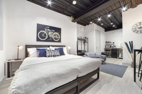 a bedroom with a large bed with a bike on the wall at Modern Luxury Studios London in London