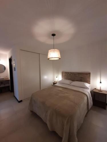 a bedroom with a large bed and a ceiling at Walüng in San Martín de los Andes