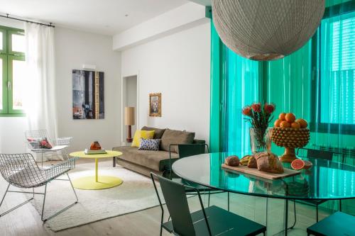 a living room with a glass table and a couch at Calatrava - Darya Living in Madrid