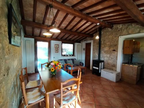 a dining room with a wooden table and chairs at Casale Eredità in Orte