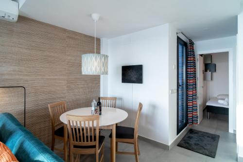 a dining room with a table and a couch at Terrazas de Ladera Duplex 7 Casasol in Nerja