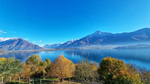 a view of a lake with mountains in the background at Il Giardino Di Lory in Vercana