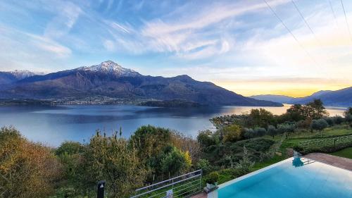 a view of a lake and mountains with a swimming pool at Il Giardino Di Lory in Vercana
