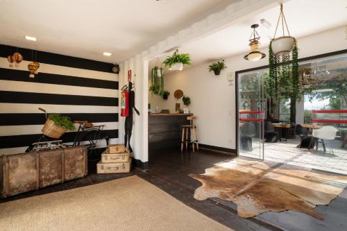 a living room with black and white stripes on the wall at Pousada Cafe Poesia in Campos do Jordão