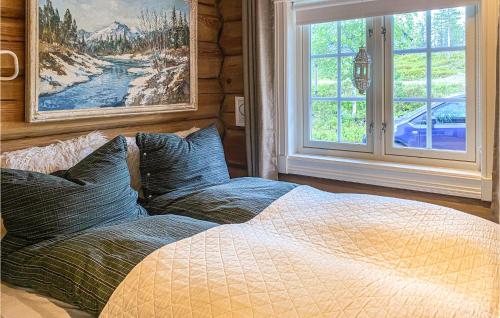 a bedroom with a bed with pillows and a window at Beautiful Home In Vang P Hedmark With 3 Bedrooms in Sæli